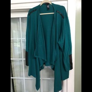 Catherine’s 4X green cardigan with faux leather